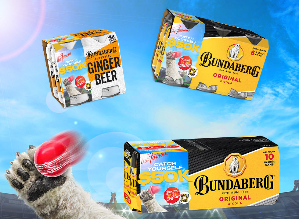 Polar bear paw bats a red cricket ball toward three floating Bundaberg beer multipacks above a stadium under a bright blue sky.
