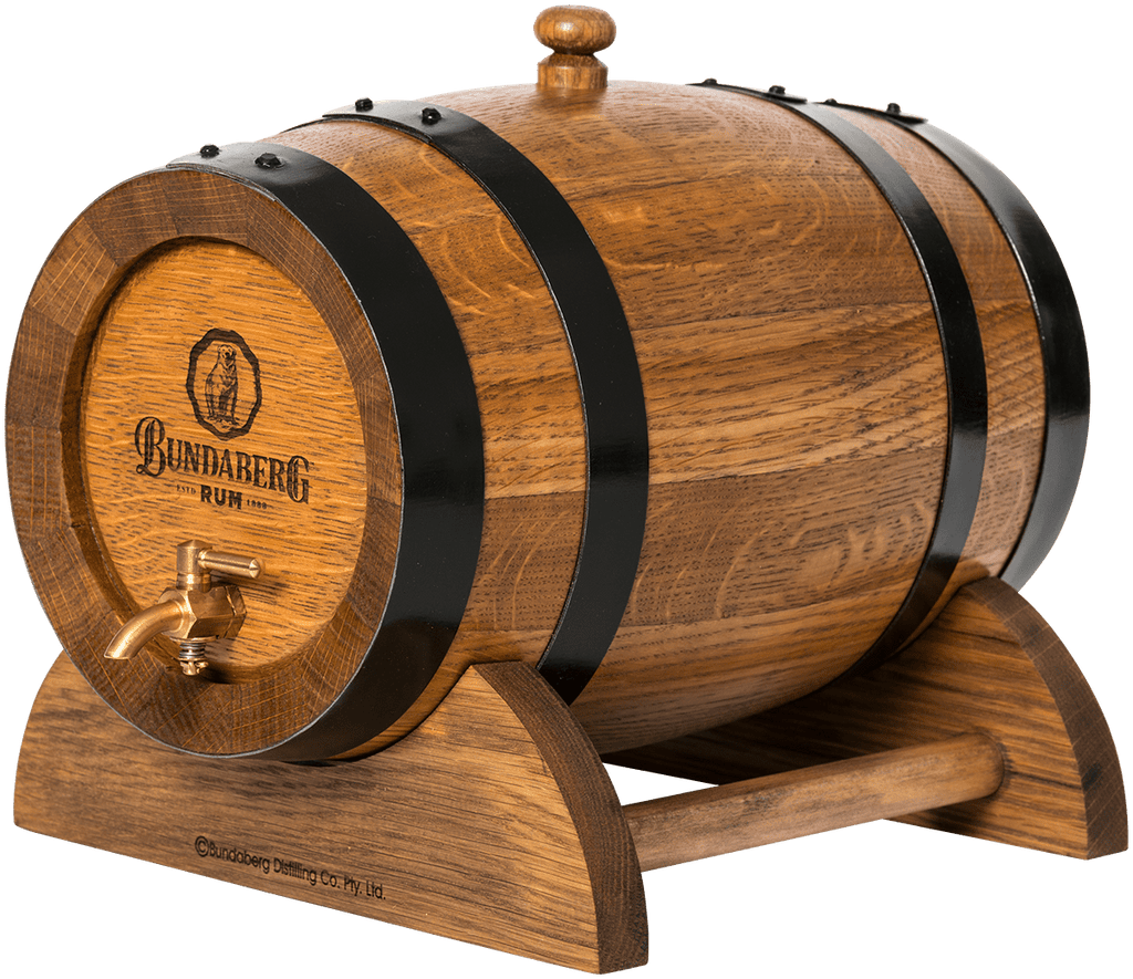 Wooden rum barrel rests on a curved wooden stand, bound by black metal hoops, topped with a wooden bung and fitted with a brass spigot, shown on a plain background.