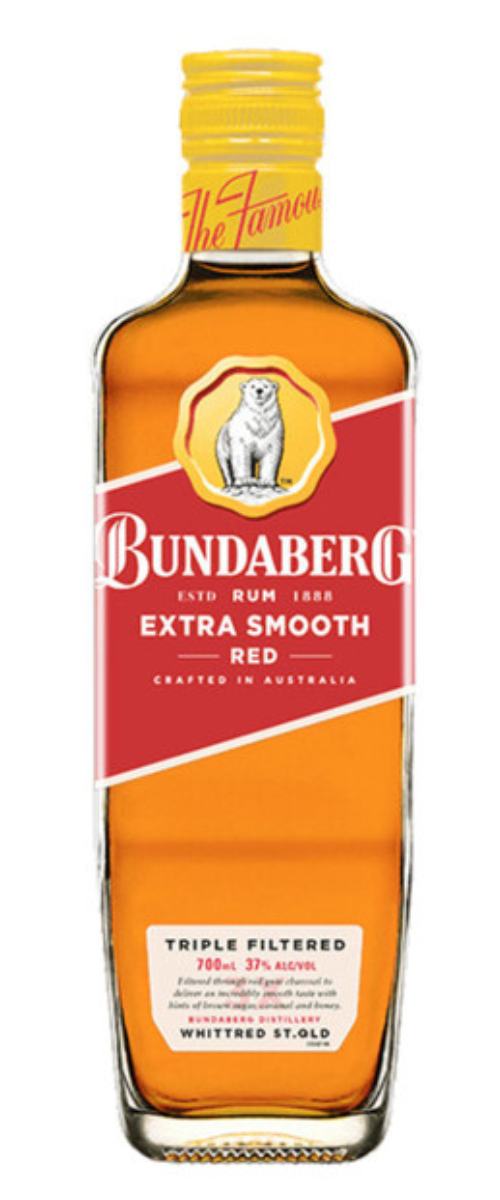 A Bundaberg rum bottle stands upright on a white background, amber liquid visible through glass; red-and-white label faces forward. Text on label: "BUNDABERG" and "EXTRA SMOOTH" (small print unreadable).