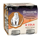 A cardboard four-pack of Bundaberg Campfire canned drinks sits angled, showing a polar bear logo and warm brown label design against a plain white background.