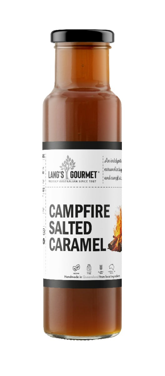 A tall glass bottle stands upright on a white background, filled with brown sauce; label shows a small flame illustration.
