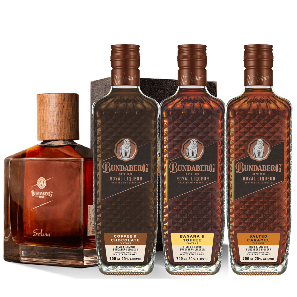 Four liquor bottles stand upright side-by-side on a plain background: three tall Bundaberg rum liqueur bottles and one shorter square bottle labeled "Solera."