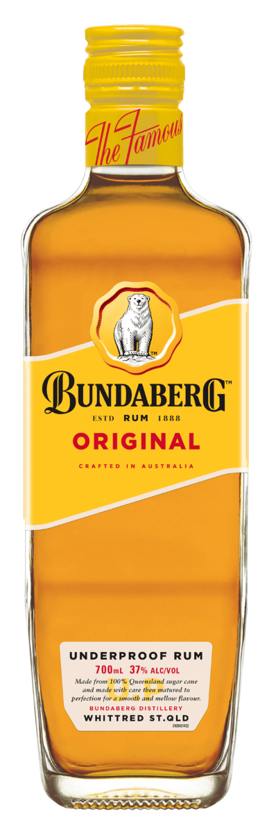 Glass bottle of Bundaberg Rum stands upright on a white background, showing amber liquid and a yellow koala-branded label reading product name and variant.