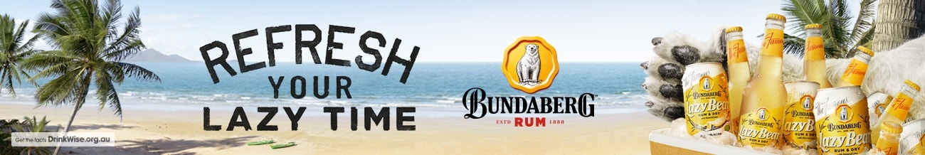 Banner image displaying a beach, the ocean and palm trees, with an esky filled with Bundaberg Rum Lazy Bear mixed drink bottles and cans to the side.